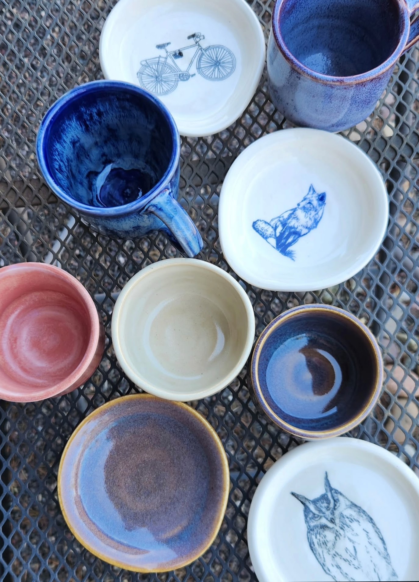 Small ceramic dishes with fox, owl, and bicycle stamp motifs