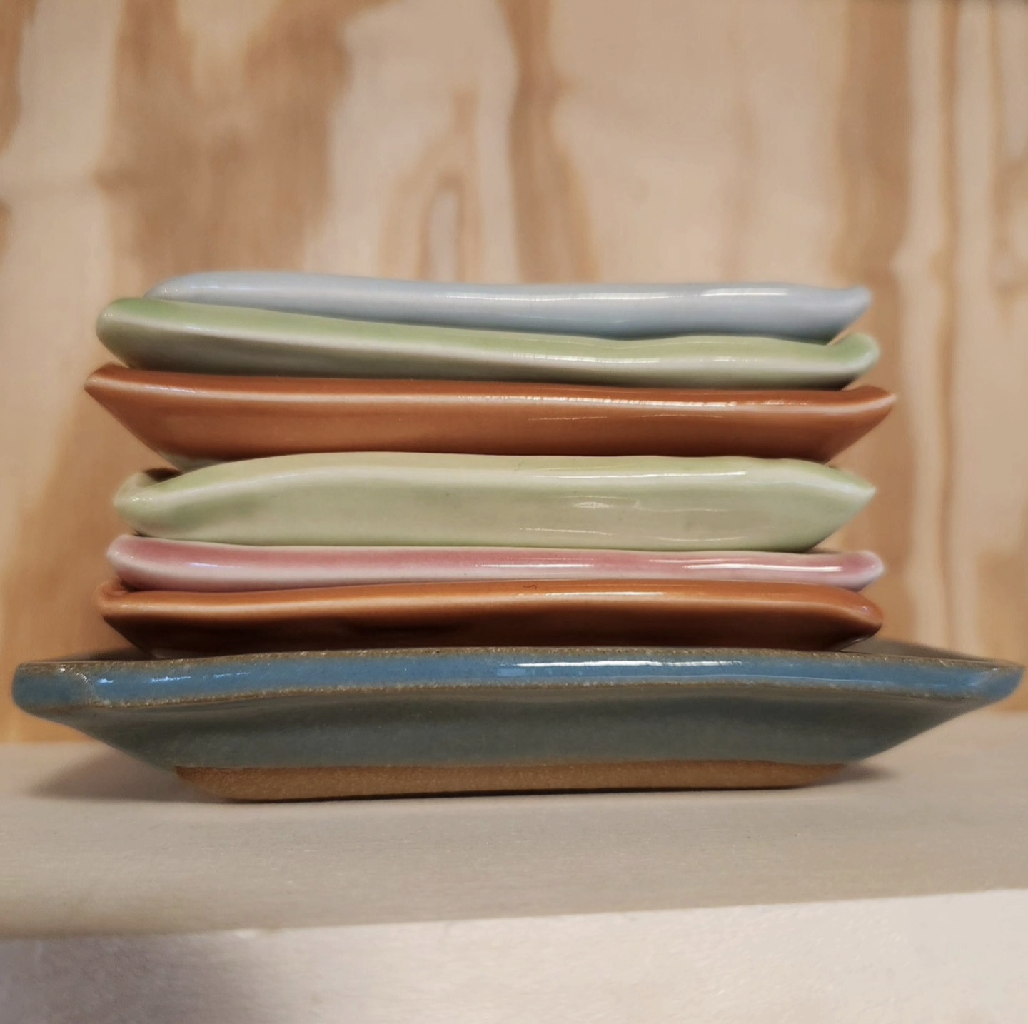 Stack of colorful ceramic spoon rests