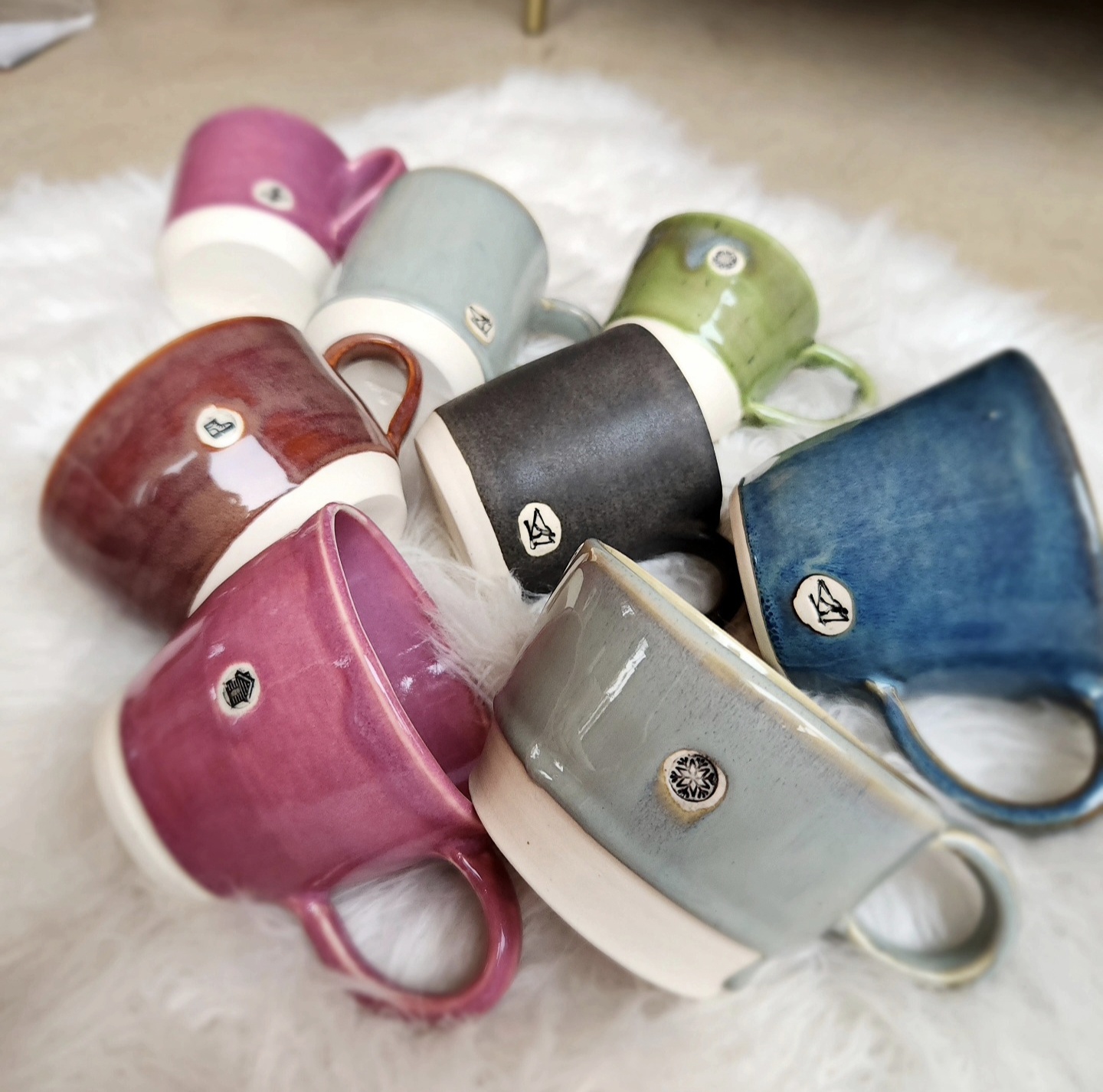 Pile of colorful half-dip glazed mugs