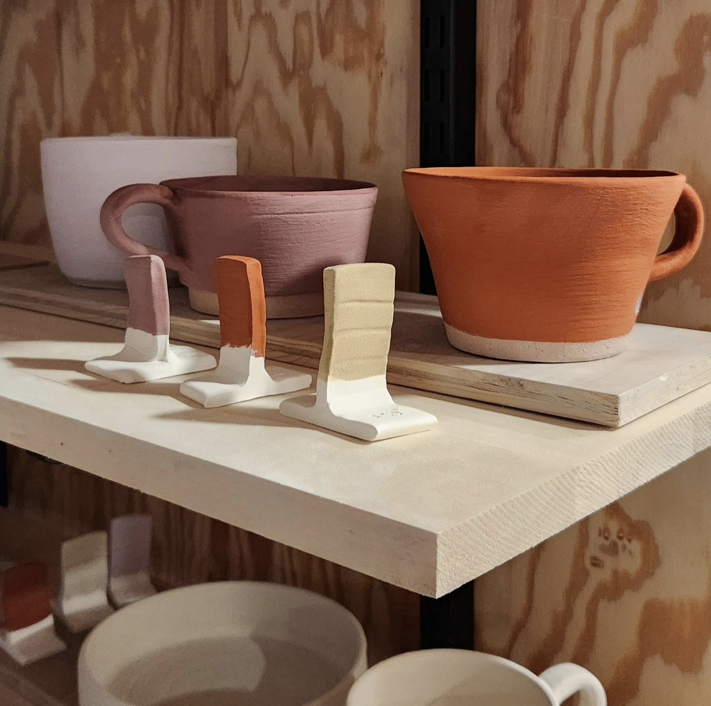 Pottery pieces on a studio shelf